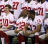 Giants quarterback Manning sits with teammates for a team picture during media day for the NFL Super Bowl XLVI in Indianapolis
